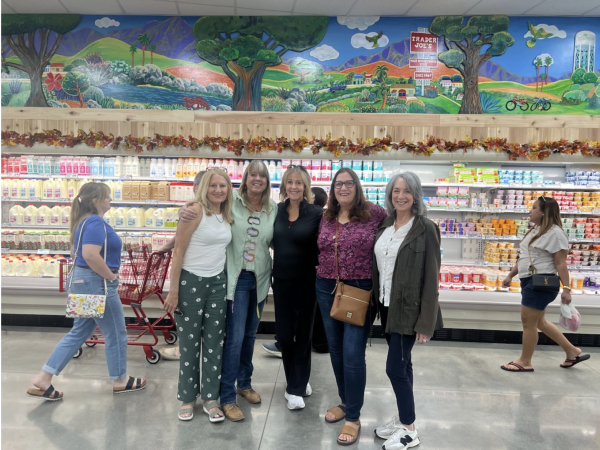 Ms. Trimarchi and a group of her friends in front of the finished mural in Trader Joe’s.